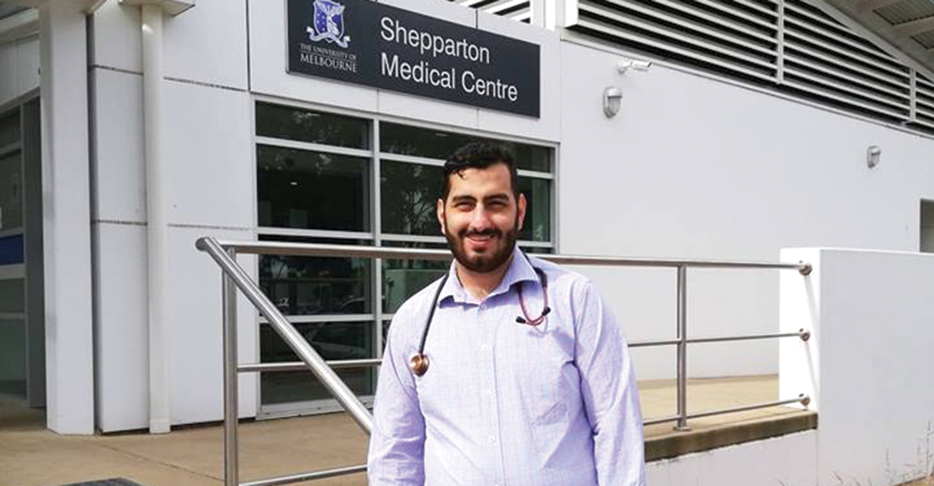 A young rural doctor standing in front of Shepparton Medical Centre.